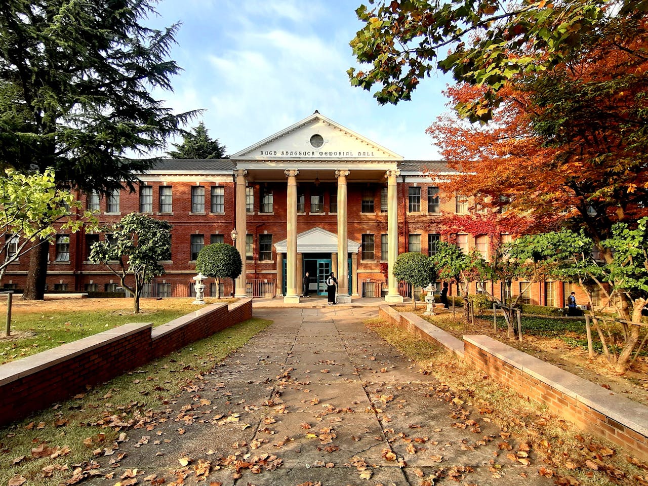 A beautiful university building in Daegu, South Korea, surrounded by autumn foliage.